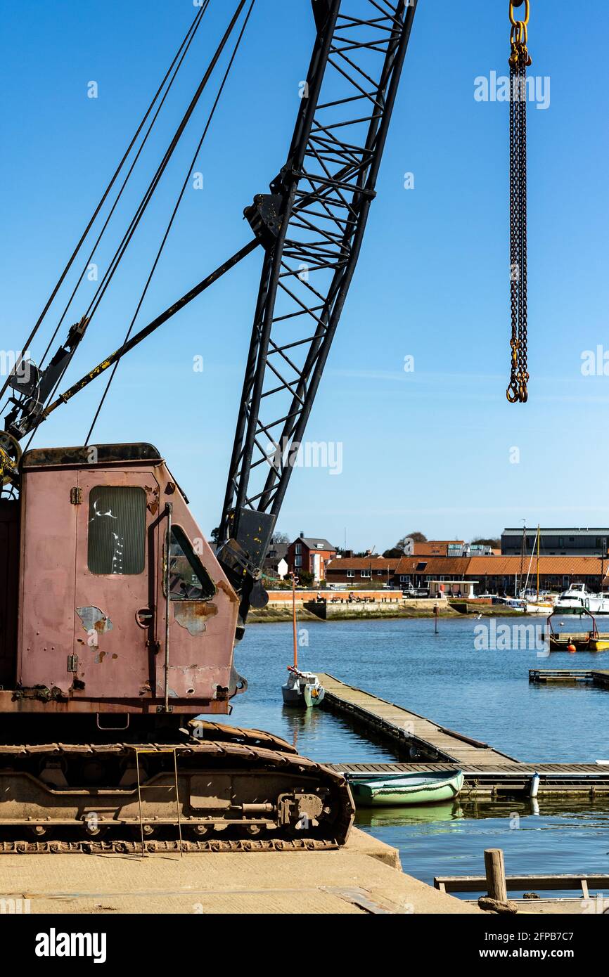 A small crane mounted on the edge of the River Deben used to move boats in and out of the river and to suspend while cleaning and maintaining Stock Photo