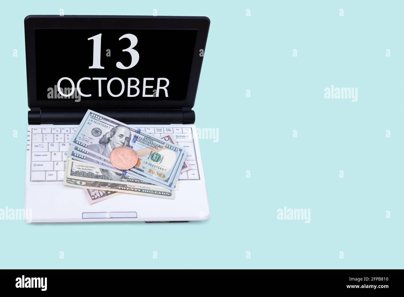 13th day of october. Laptop with the date of 13 october and cryptocurrency  Bitcoin, dollars on a blue background. Buy or sell cryptocurrency. Stock ma  Stock Photo - Alamy
