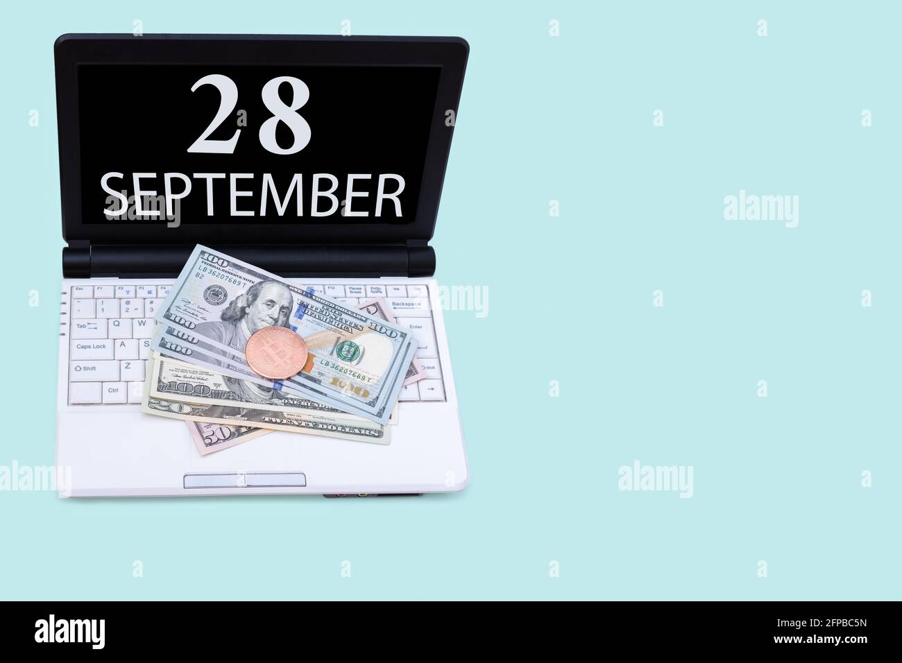 28th day of september. Laptop with the date of 28 september and cryptocurrency  Bitcoin, dollars on a blue background. Buy or sell cryptocurrency. Stoc  Stock Photo - Alamy