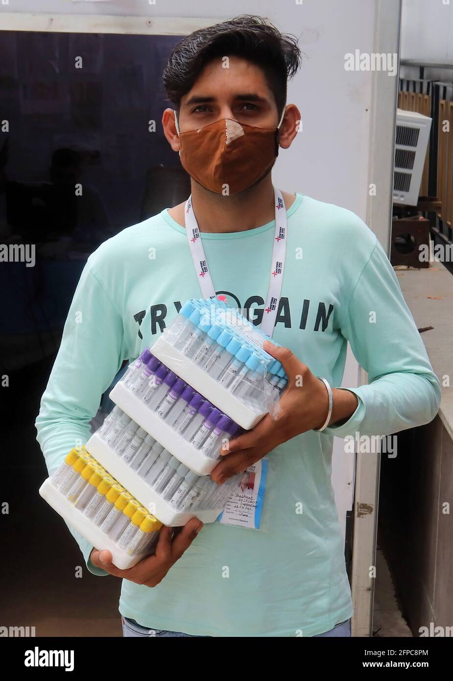 New Delhi, India. 20th May, 2021. A healthcare worker holds empty testing tubes for Covid-19 patients outside the isolation ward. A banquet hall temporarily converted to a Covid19 care centre for coronavirus patients. India has recorded 276,110 new cases and 3,874 deaths of coronavirus infections in the last 24 hours. (Photo by Naveen Sharma/SOPA Images/Sipa USA) Credit: Sipa USA/Alamy Live News Stock Photo