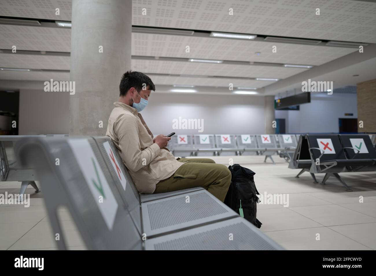 Traveler sits at international airport of Cyprus, Paphos during COVID19 crisis, sits in