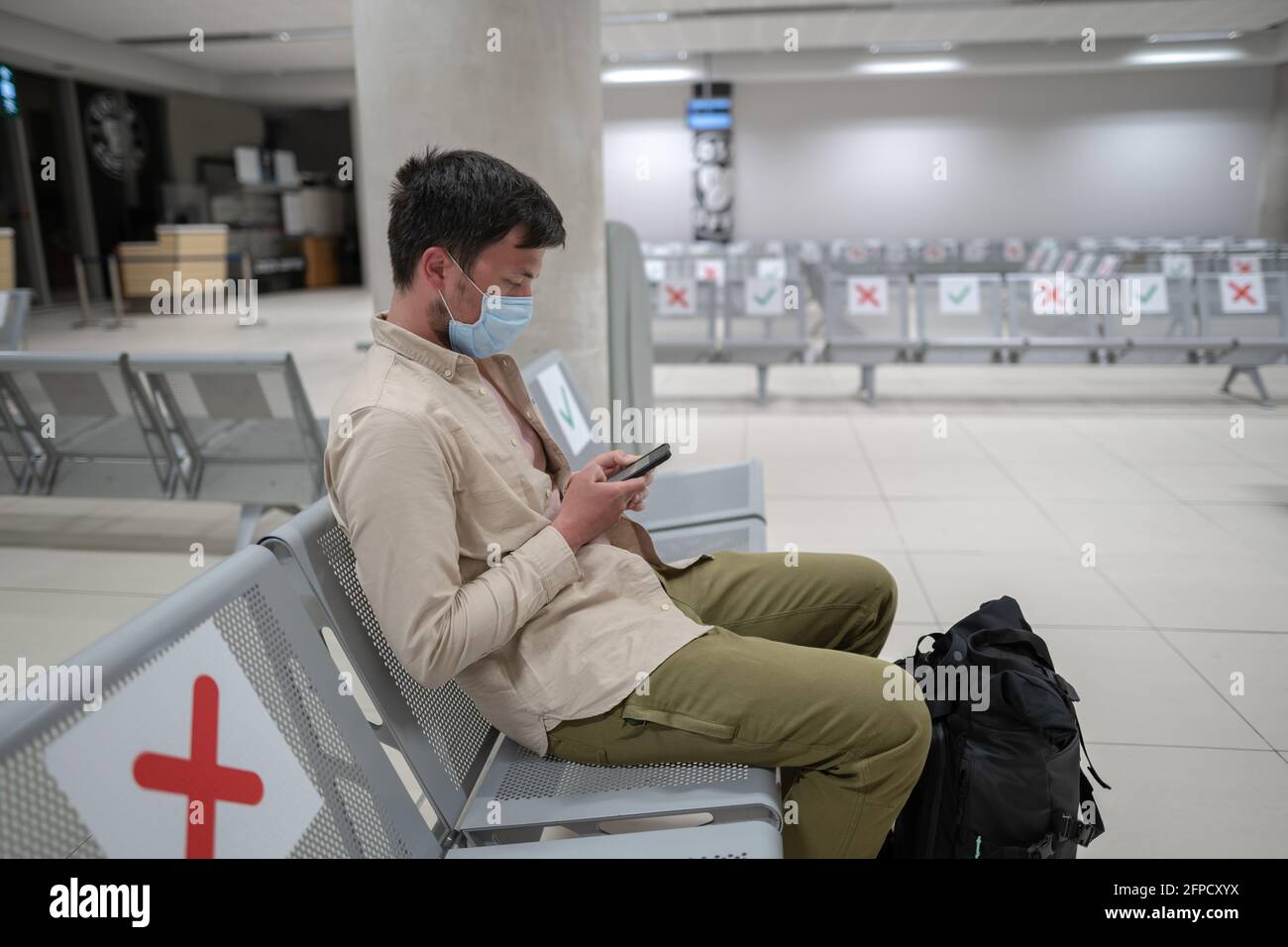 Traveler sits at international airport of Cyprus, Paphos during COVID19 crisis, sits in