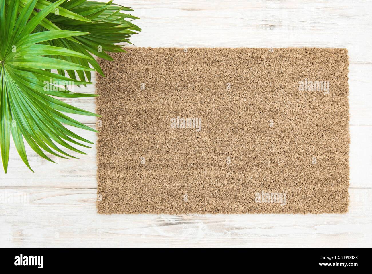 Coir doormat mockup with palm leaves decoration. Floral template mock up Stock Photo