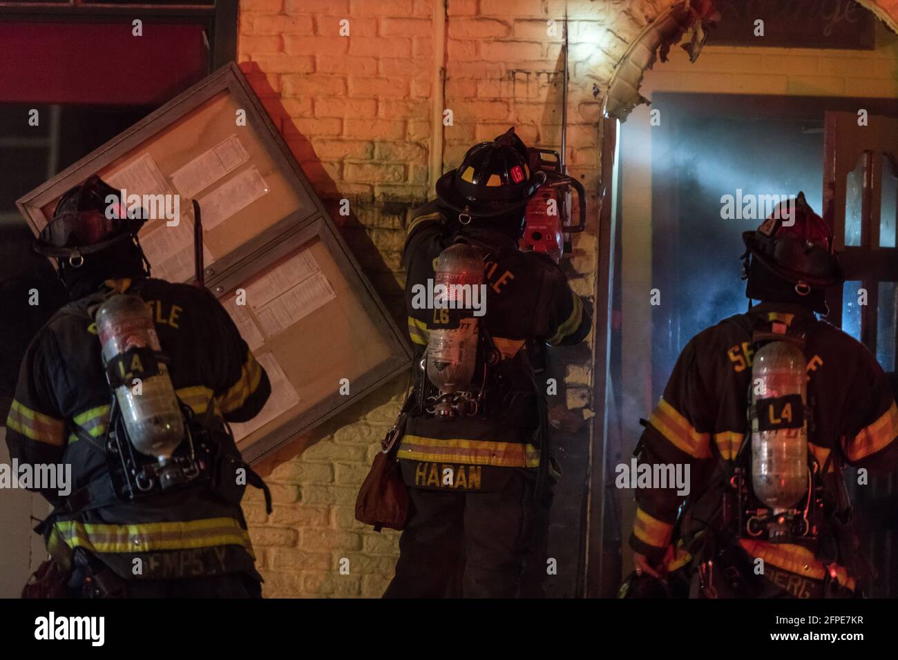 Seattle, USA. 18th Apr, 2021. Seattle Fire Department putting out hotspots after responding to a structure fire at Pesos restaurant in Lower Queen Ann Stock Photo