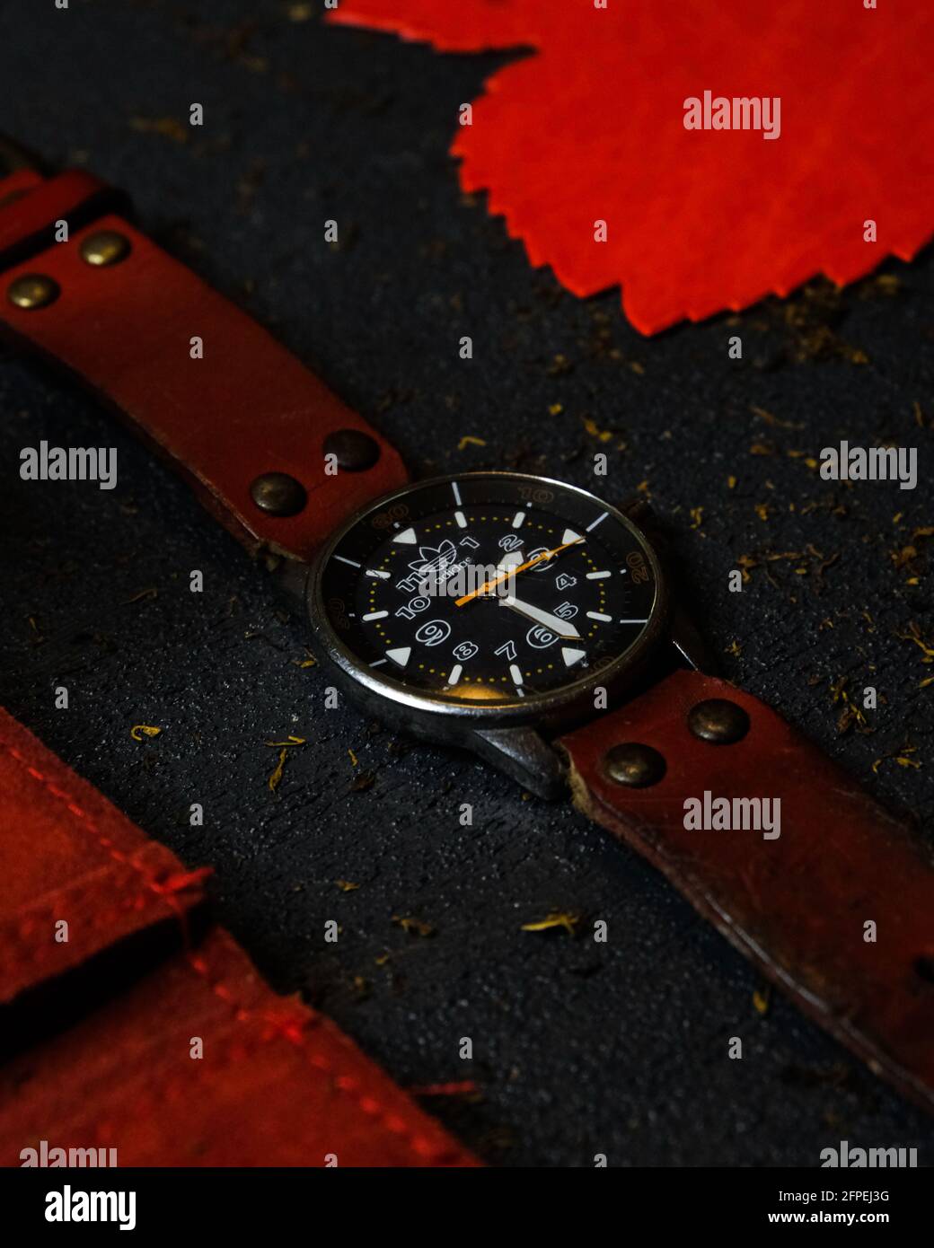 Antalya,Turkey - 15 May 2021: Adidas Originals vintage watch(10-0053B) with  a red strap on black background with surroundings Stock Photo - Alamy