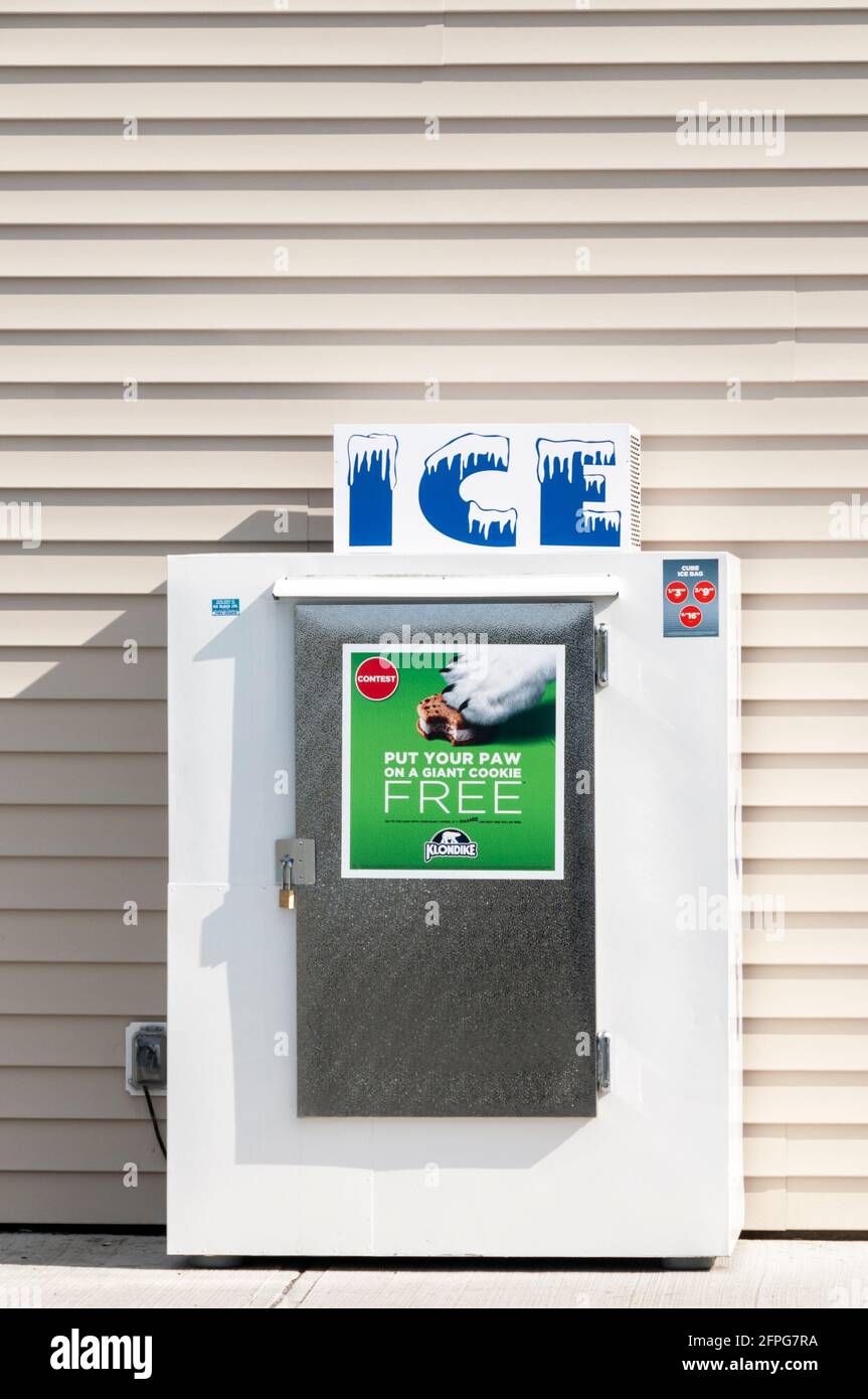 Ice for sale from a refrigerator outside a Canadian filling station. Stock Photo