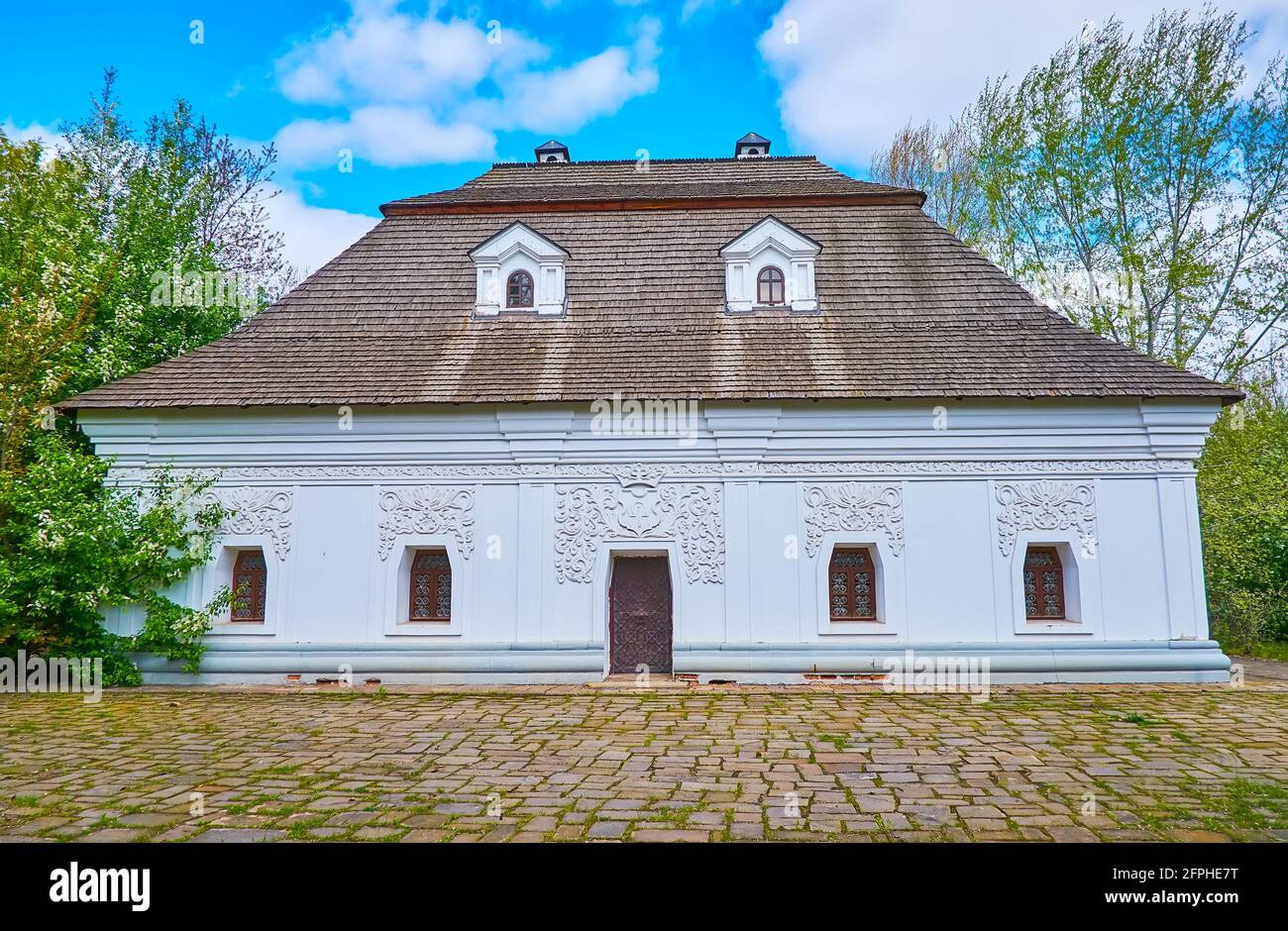 The Ukrainian Baroque style Sotnyk's (Cossack military officer) mansion with moulding, traditional patterns and wooden scale roof, Mamajeva Sloboda Co Stock Photo