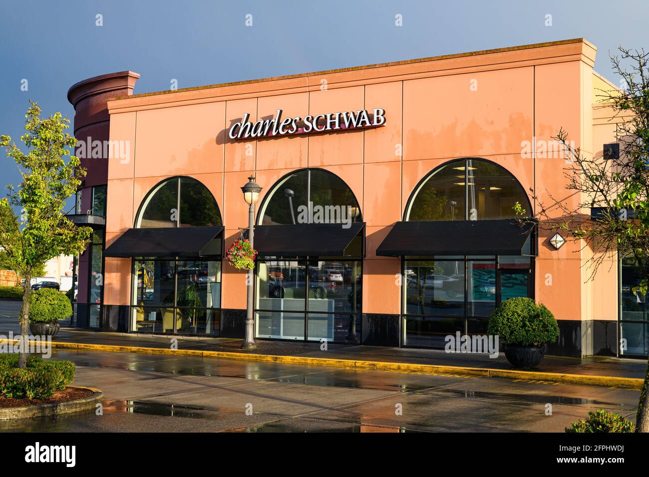 Redmond, WA, USA - May 20, 2021; Redmond office of the Charles Schwab financial business at the Bella Bottega Shopping Center after a rain storm Stock Photo
