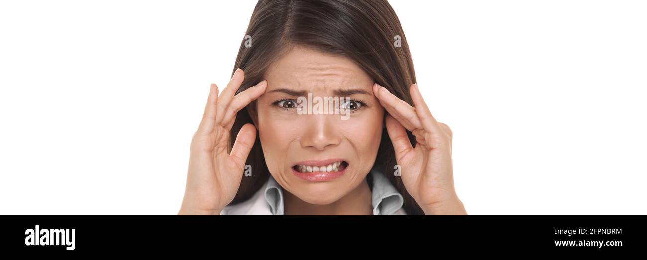 Stressed out funny Asian woman doing a scared panic facial expression in worry holding head for headache or migraine. Portrait olated on white Stock Photo