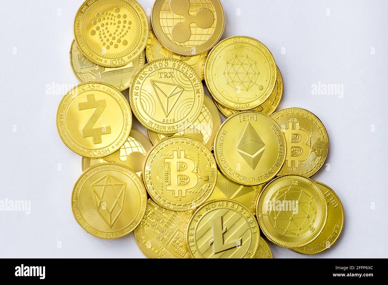 Summary of cryptocurrency coins bitcoin litecoin ethereum tron zcash  ethereum eos iota ripple and qtum lying on a blue background Stock Photo -  Alamy
