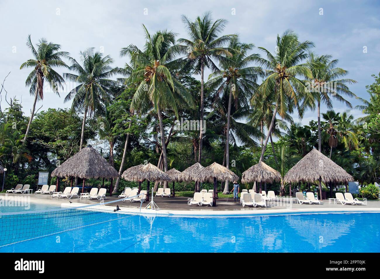 Pool with palm trees and palapas at resort in Tamarindo, Costa Rica Stock Photo
