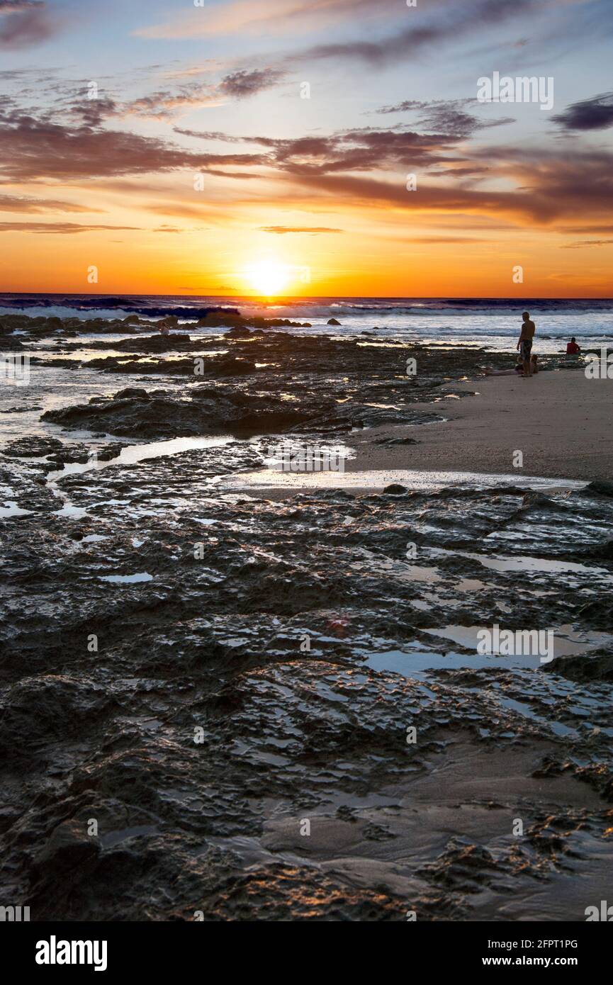 Sunset over beach with tidepools in Costa Rica Stock Photo
