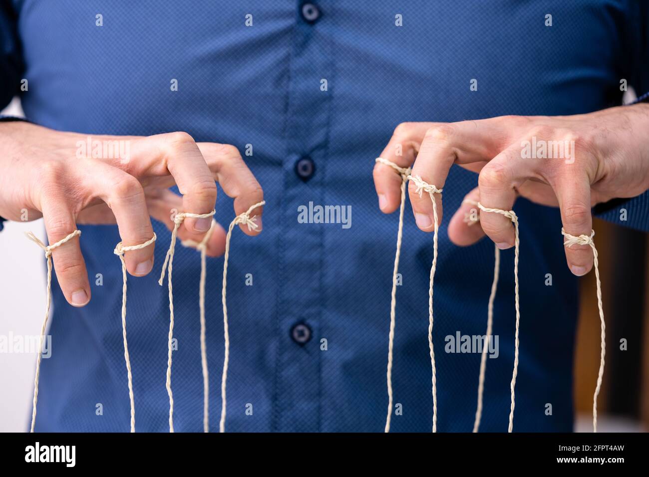 Manipulating Marionette Puppet Strings By Hand. Business Power Stock Photo