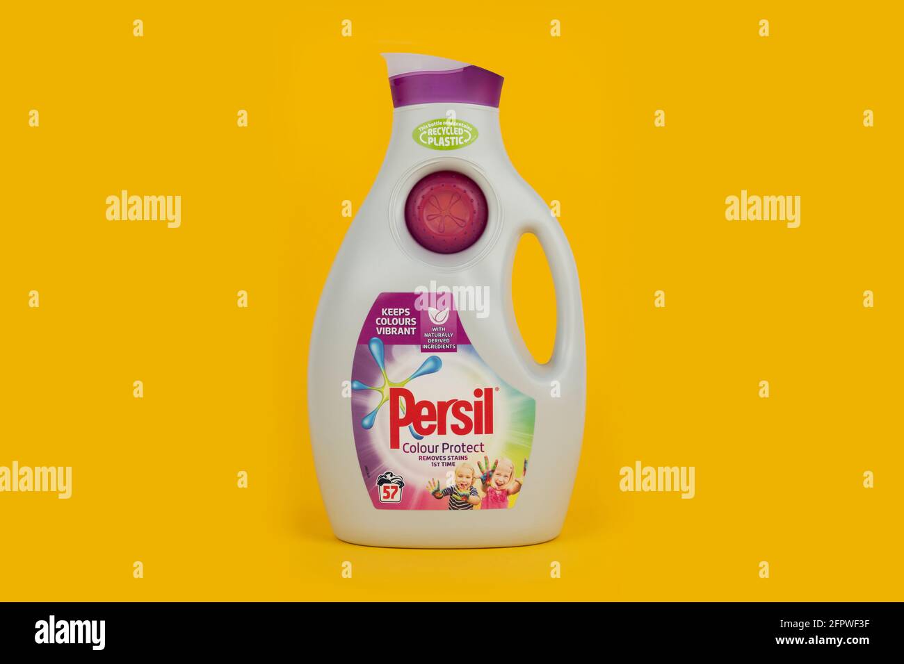A bottle of Persil Colour Protect biological liquid laundry detergent shot on a yellow background. Stock Photo