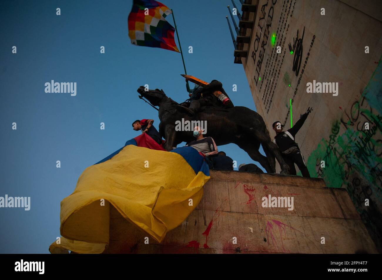 Demonstrators take the Simon Bolivar statue at Monumento a los Heroes in Northern Bogota with Colombian and indigenous flags as Colombia enters its 4t Stock Photo