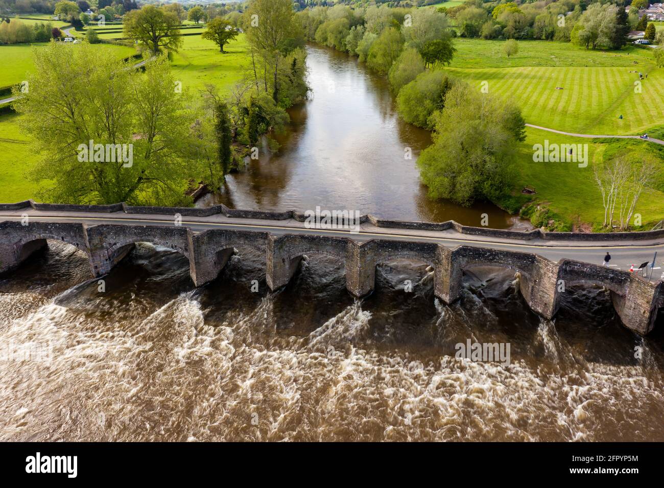 Aerial view of an old bridge across a fast flowing river (River Usk, Crickhowell, Wales) Stock Photo