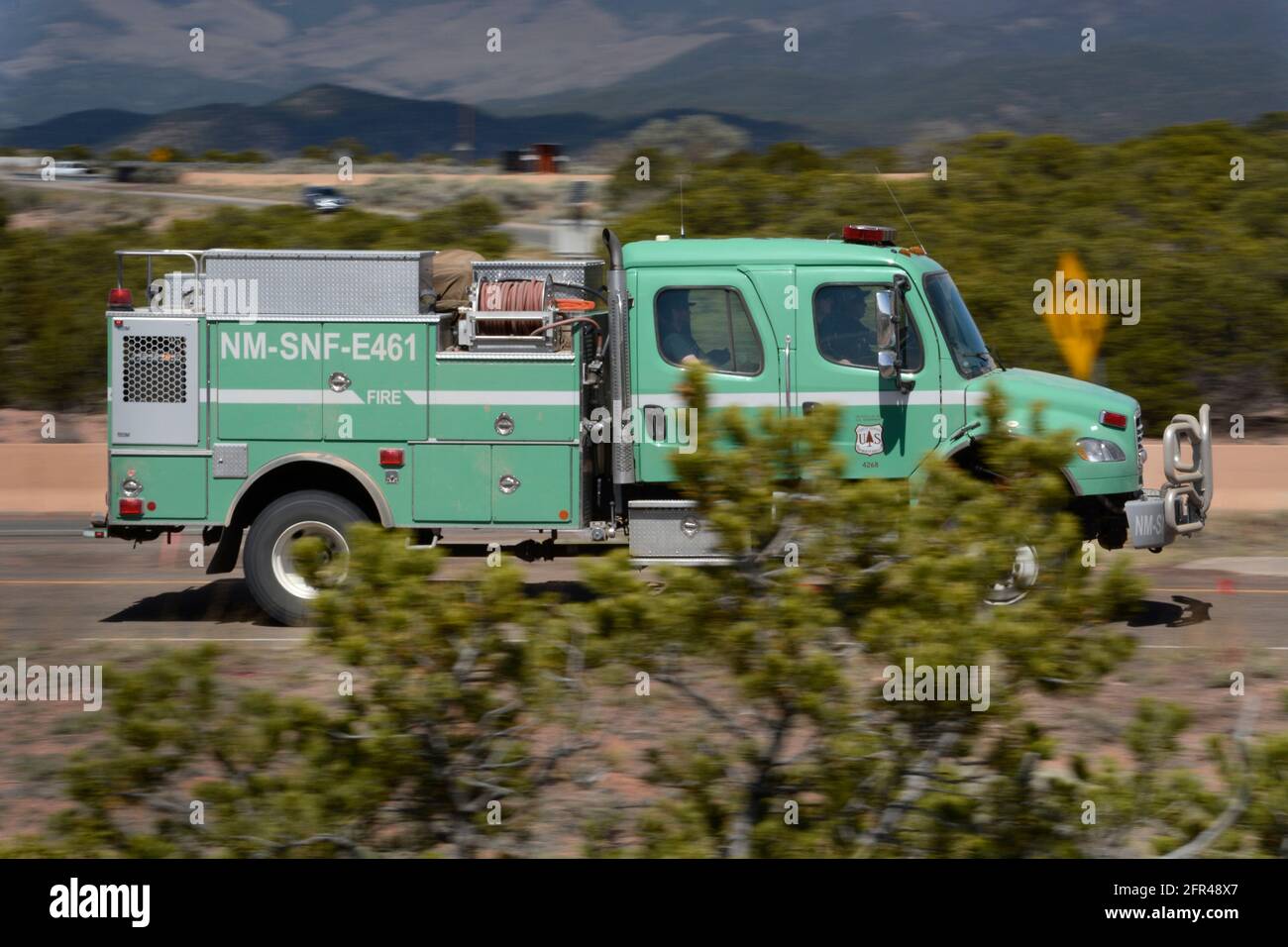 A United States Forest Service truck with firefighters aboard rushes to the site of a fire in New Mexico. Stock Photo