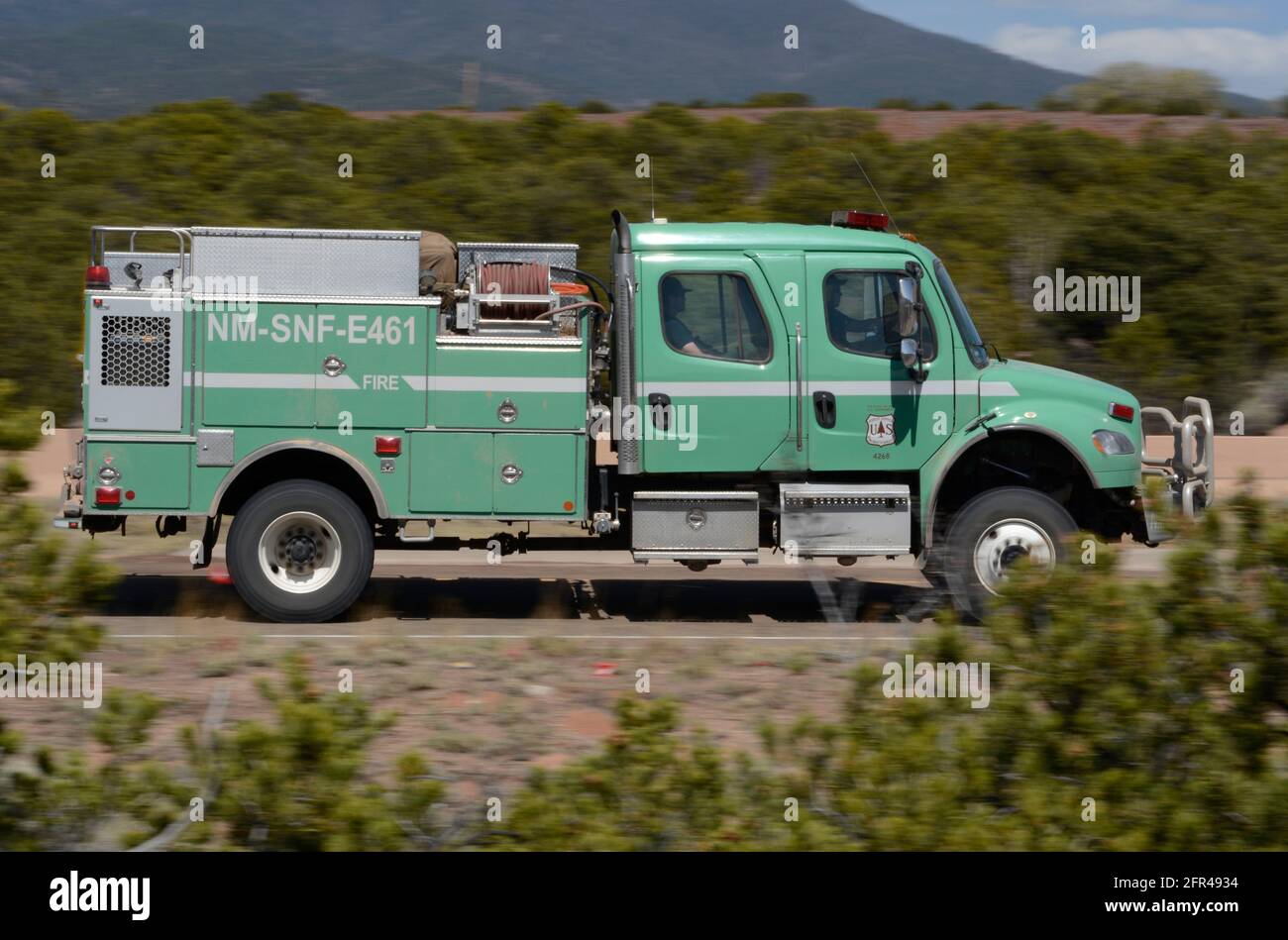 A United States Forest Service truck with firefighters aboard rushes to the site of a fire in New Mexico. Stock Photo