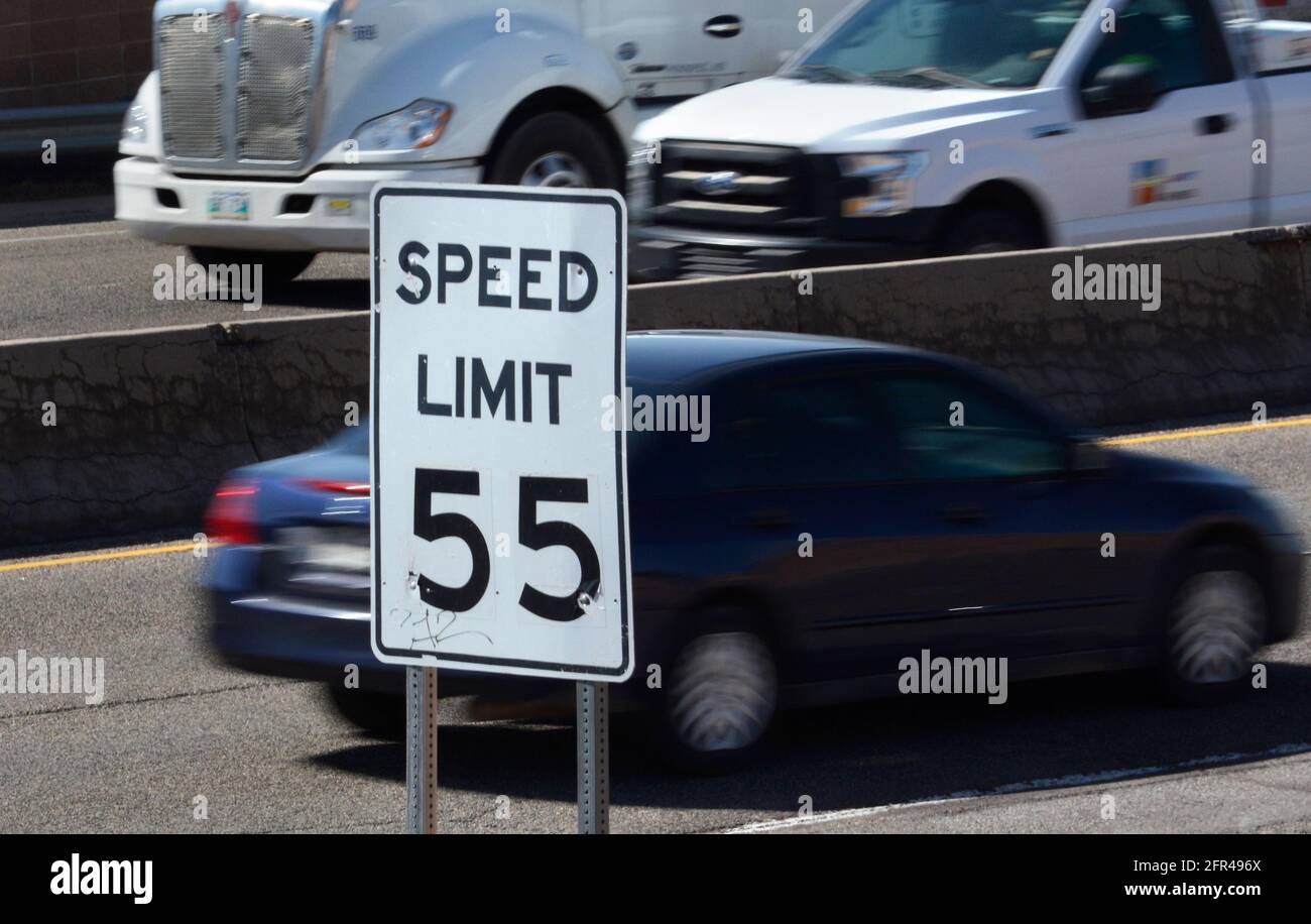 Cars and trucks travel along a New Mexico highway with a posted speed limit of 55 miles-per-hour. Stock Photo