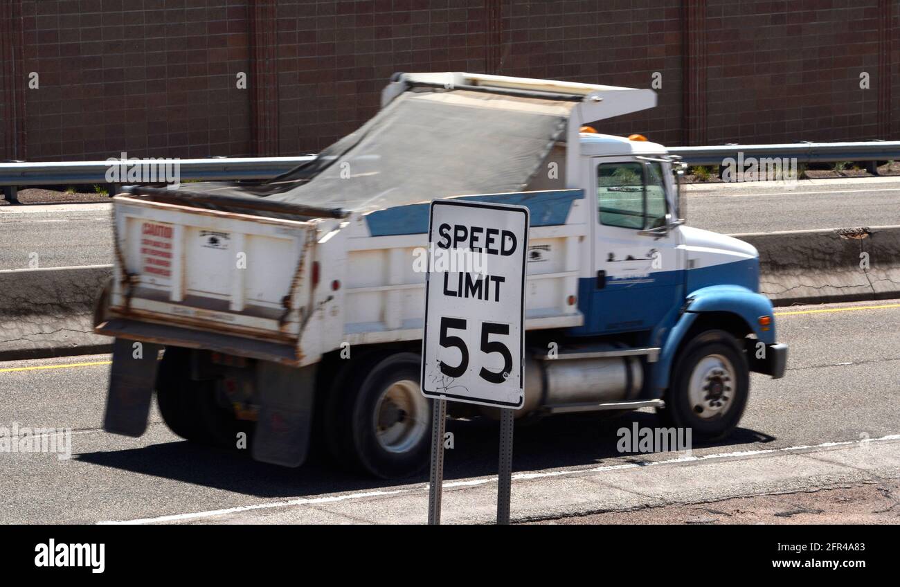 Cars and trucks travel along a New Mexico highway with a posted speed limit of 55 miles-per-hour. Stock Photo