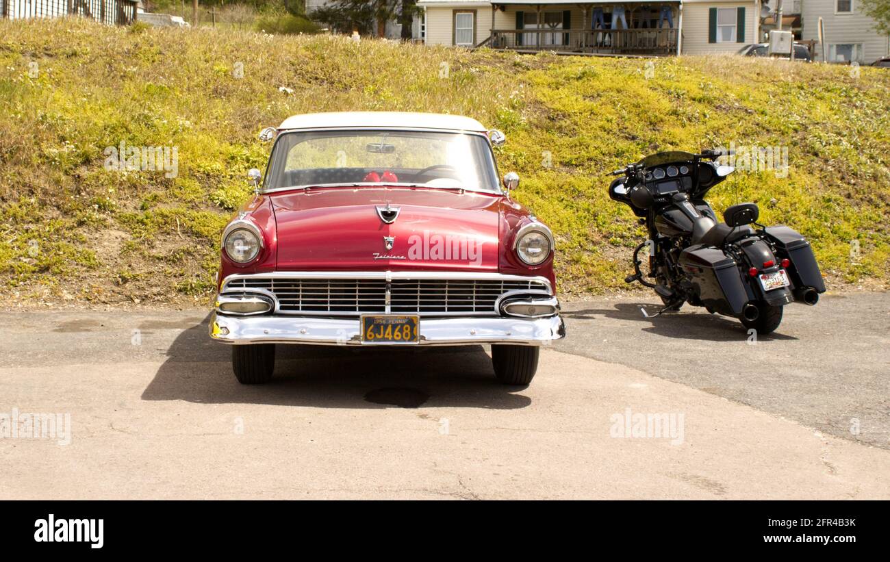 The Front of a 1956 Ford and a Motorcycle Stock Photo