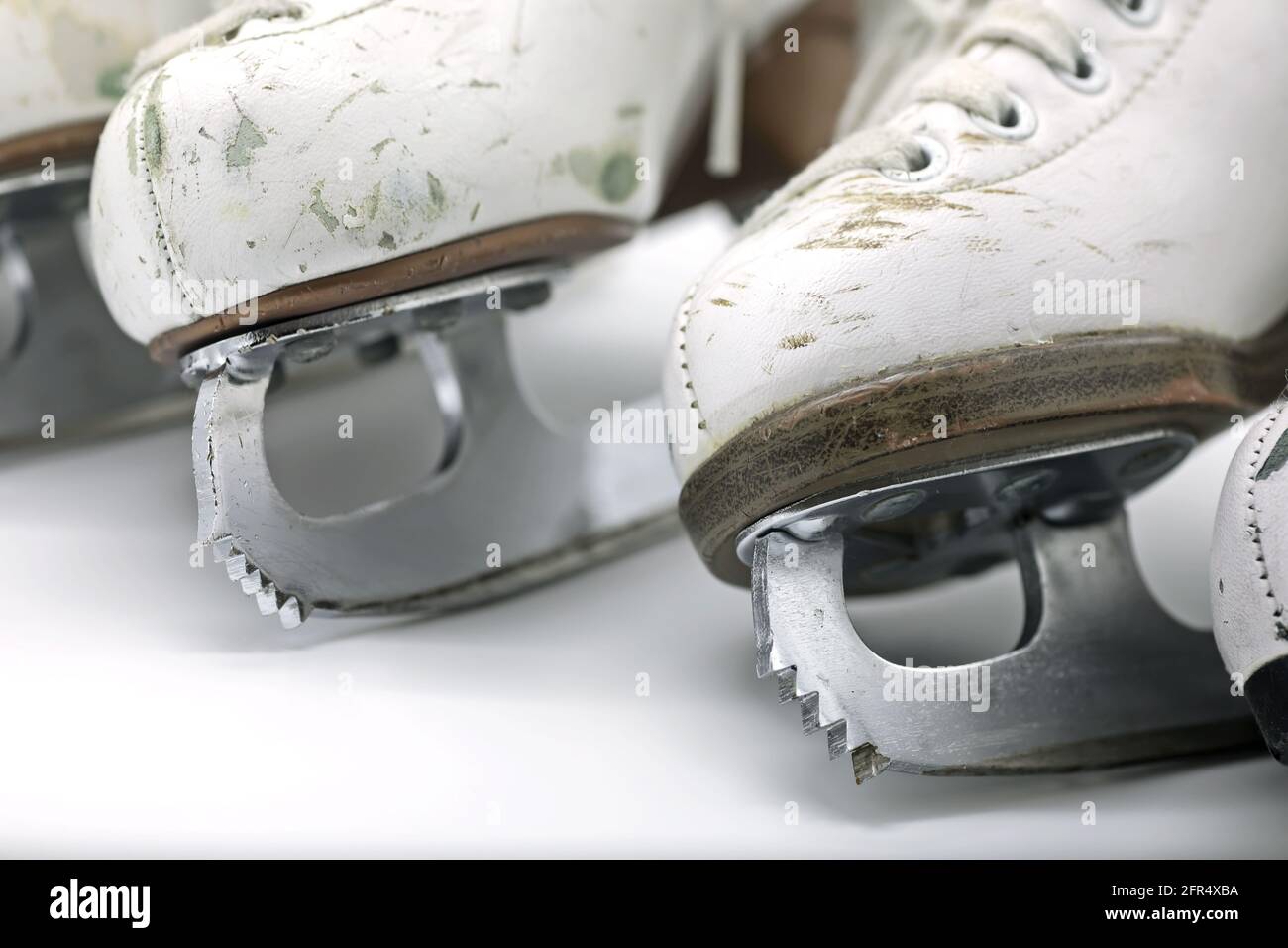 Figure skating boots with blades close-up on toe picks, white background Stock Photo