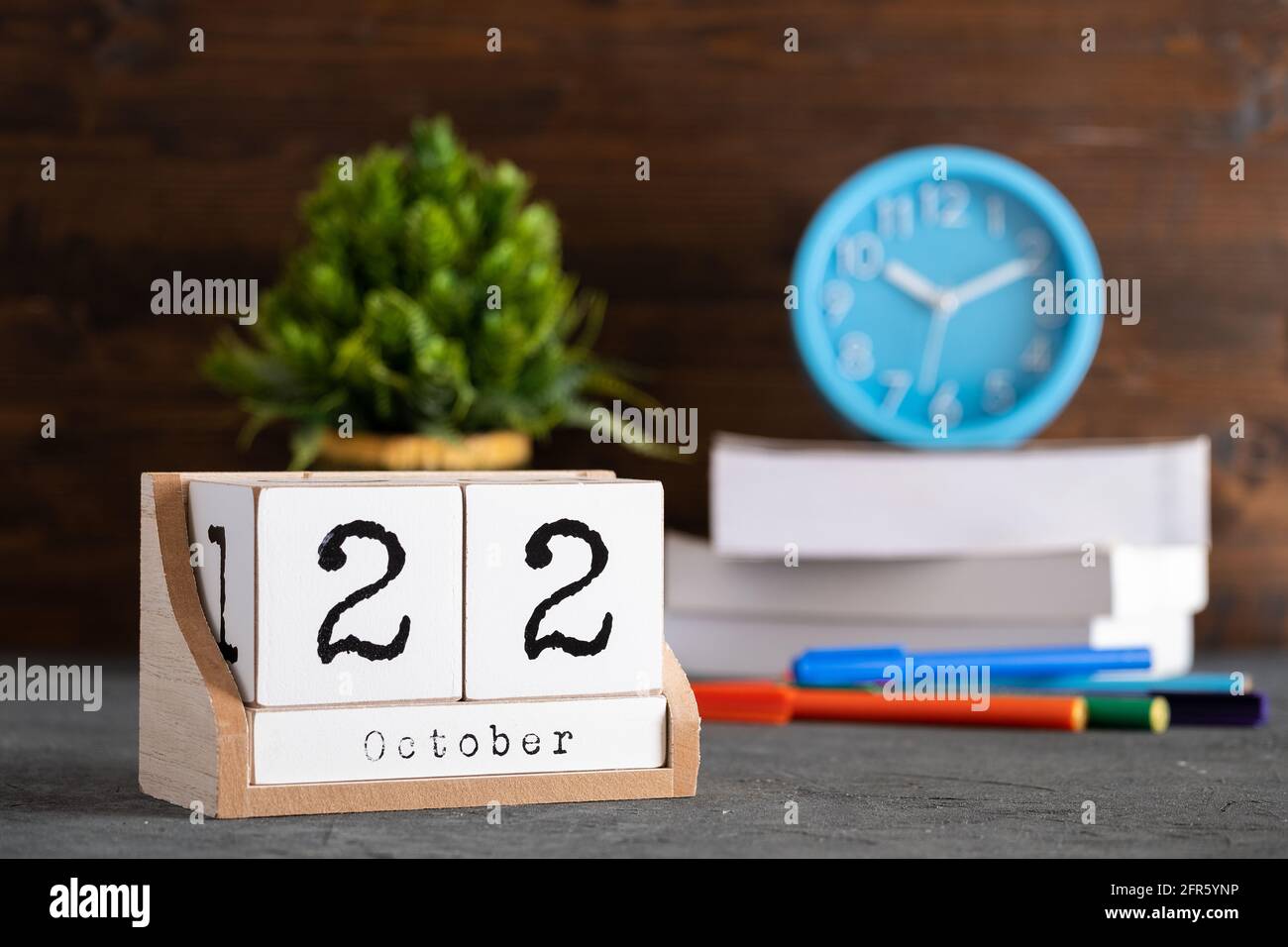 October 22nd. October 22 wooden cube calendar with blur objects on background. Stock Photo