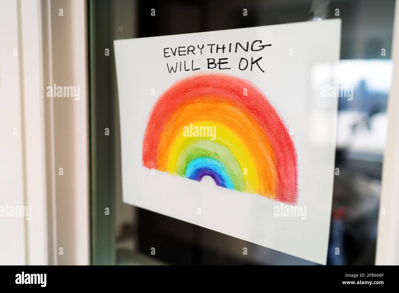 Coronavirus Rainbow campaign painting hanging at home window to spread positivity with message EVERYTHING WILL BE OK in english. UK, USA, Australia. Stock Photo