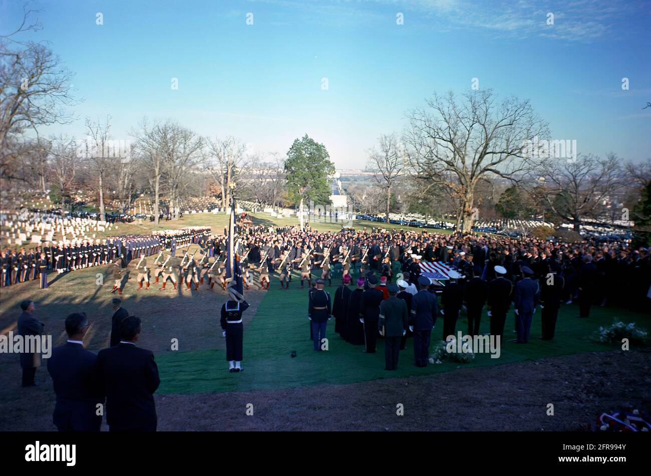 ST-C422-112-63                    25 November 1963  Burial Service for President John F. Kennedy at Arlington National Cemetery with pallbearers holding flag; Cardinal Cushing and other clergy; military aides; Irish military contingent; mourners.  Please credit 'Cecil Stoughton. White House Photographs. John F. Kennedy Presidential Library and Museum, Boston' Stock Photo