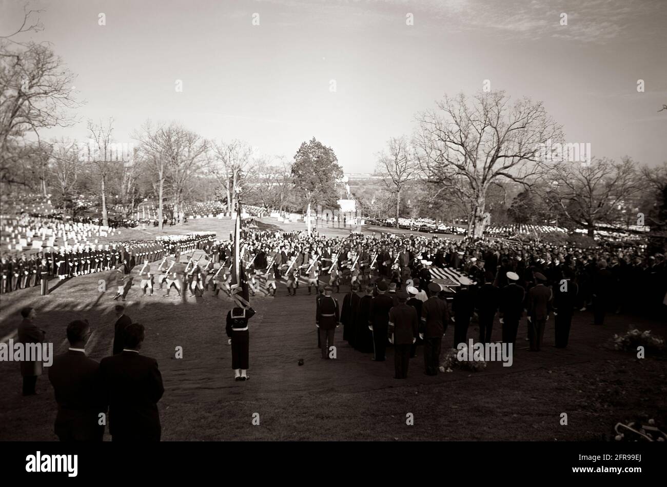 ST-C422-112-63                    25 November 1963  Burial Service for President John F. Kennedy at Arlington National Cemetery with pallbearers holding flag; Cardinal Cushing and other clergy; military aides; Irish military contingent; mourners.  Please credit 'Cecil Stoughton. White House Photographs. John F. Kennedy Presidential Library and Museum, Boston' Stock Photo