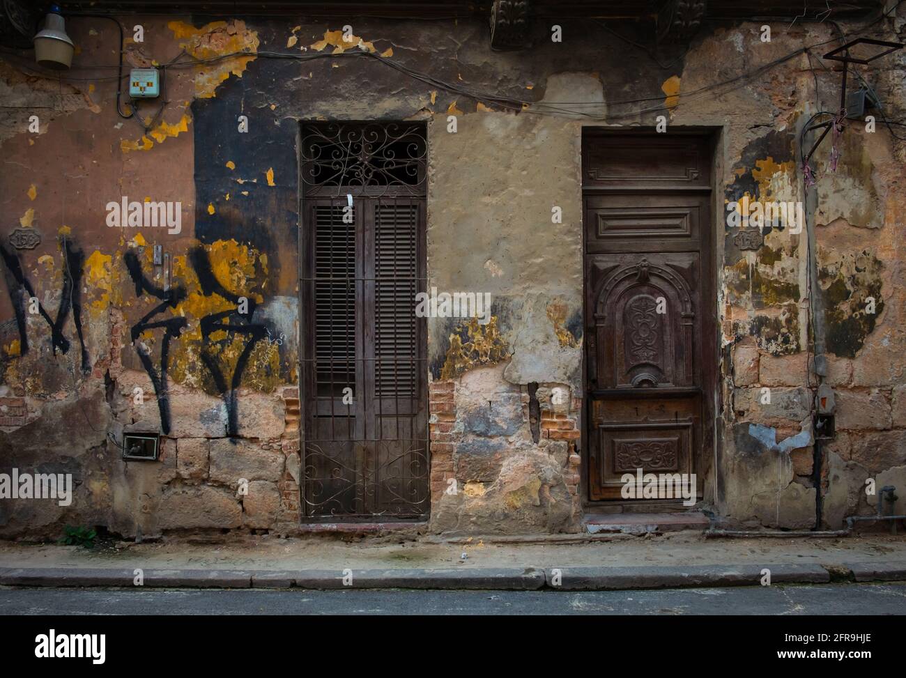 Havana, Cuba, July 2019, close up of a dilapidated exterior wall with two brown doors  in the old part of the city Stock Photo