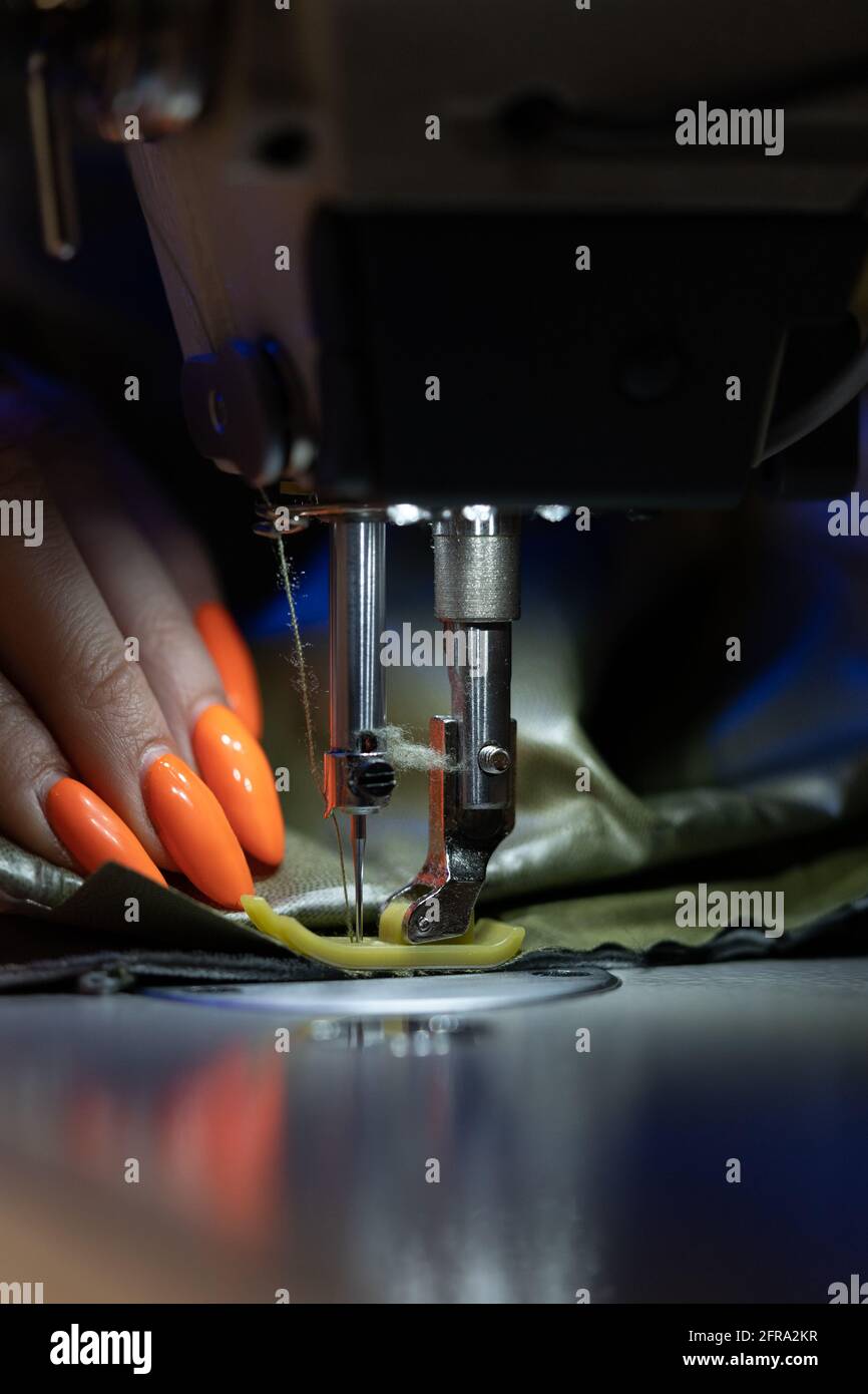 Tailoring Machine Work Closeup of female tailor work on sewing machine stitch fabric patterns ...