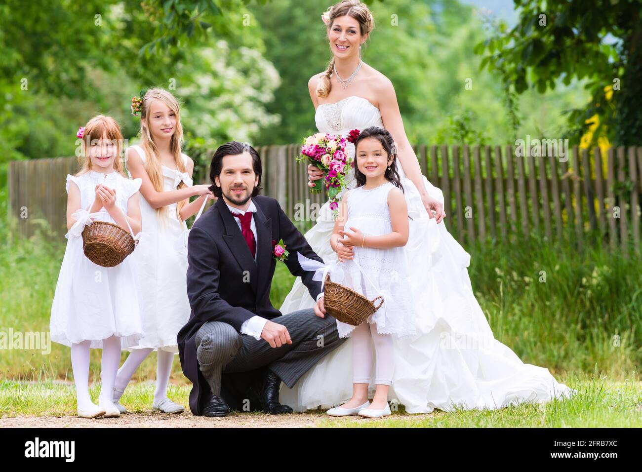 Bridal couple at wedding with bridesmaid children Stock Photo - Alamy