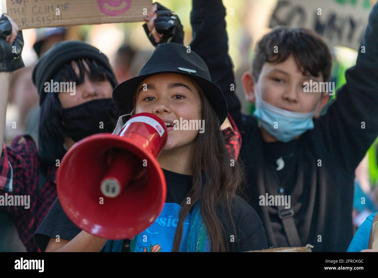 Melbourne, Australia 21 May 2021, A young girl uses a megaphone during a rally that brought 1000s of school students and supporters to the streets  of Melbourne for the 'Schools Strike 4 Climate' protests that called on governments around the world to take action on Climate change. Credit: Michael Currie/Alamy Live News Stock Photo
