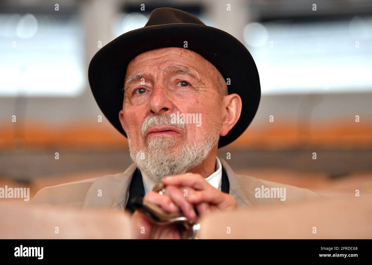 Meiningen, Germany. 19th May, 2021. Markus Lüpertz, painter and sculptor, is sitting in the auditorium of the Staatstheater Meiningen. He will bring the opera 'La Bohème' by composer Giacomo Puccini (1885-1924) to the Meiningen stage. In addition to stage design and costume design, the 80-year-old will also be responsible for directing for the first time. The premiere of this opera production is scheduled for 10 December. Credit: Martin Schutt/dpa-Zentralbild/dpa/Alamy Live News Stock Photo