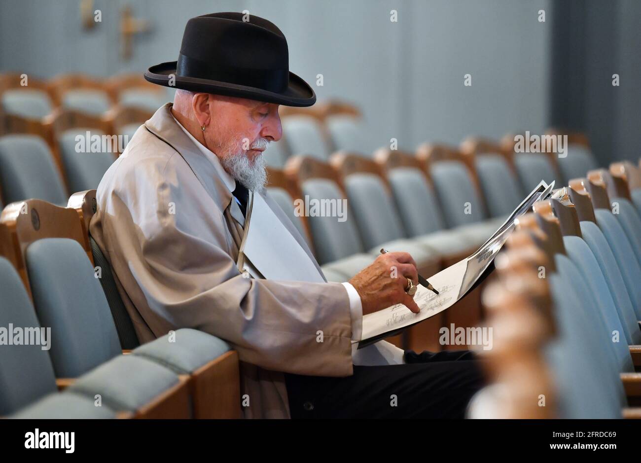 Meiningen, Germany. 19th May, 2021. Markus Lüpertz, painter and sculptor, is sitting in the auditorium of the Staatstheater Meiningen. He will bring the opera 'La Bohème' by composer Giacomo Puccini (1885-1924) to the Meiningen stage. In addition to stage design and costume design, the 80-year-old will also be responsible for directing for the first time. The premiere of this opera production is scheduled for 10 December. Credit: Martin Schutt/dpa-Zentralbild/dpa/Alamy Live News Stock Photo