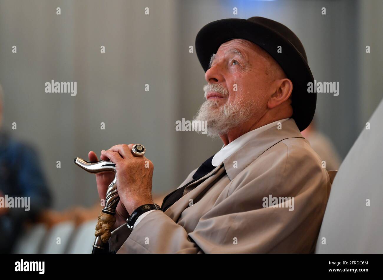 Meiningen, Germany. 19th May, 2021. Markus Lüpertz, painter and sculptor, is sitting in the auditorium of the Staatstheater Meiningen. He will bring the opera 'La Bohème' by composer Giacomo Puccini (1885-1924) to the Meiningen stage. In addition to stage design and costume design, the 80-year-old will also be responsible for directing for the first time. The premiere of this opera production is scheduled for 10 December. Credit: Martin Schutt/dpa-Zentralbild/dpa/Alamy Live News Stock Photo