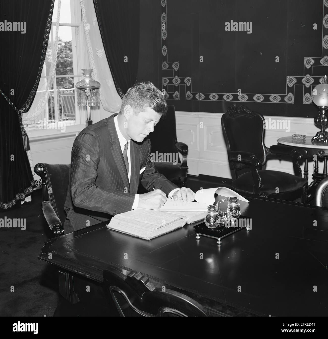 President Kennedy signs a document in the Treaty Room of the White House in Washington, DC.  Photographer: Robert Knudsen, the White House . Stock Photo