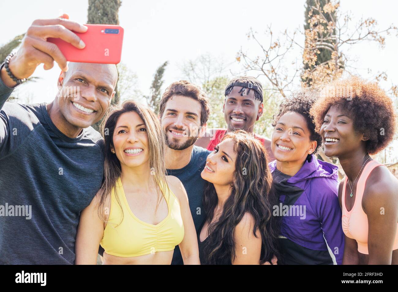 Group of runners taking a selfie in a park. Happy and smiling. Stock Photo