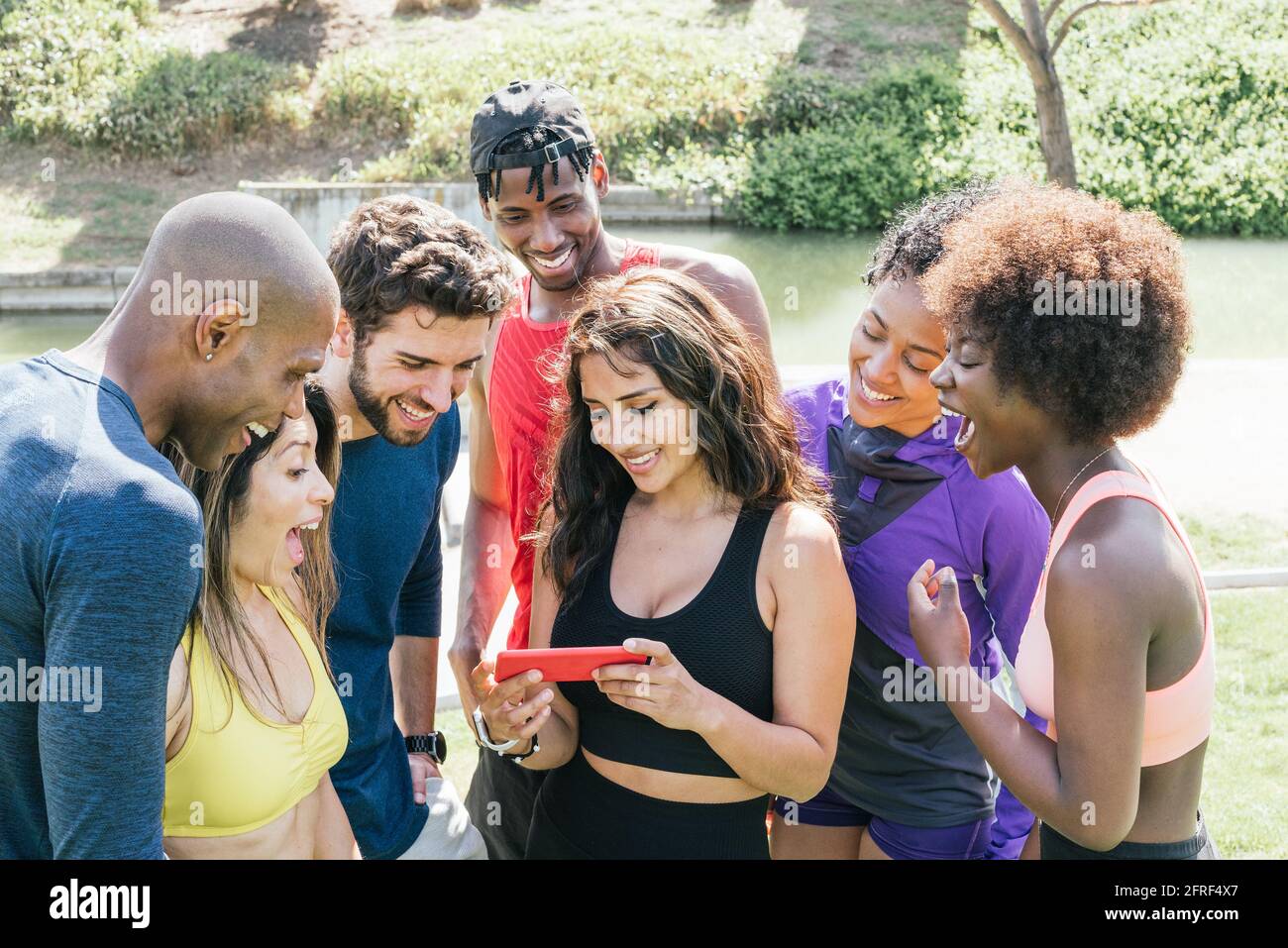 Group of runners looking at something very funny on a mobile. Stock Photo