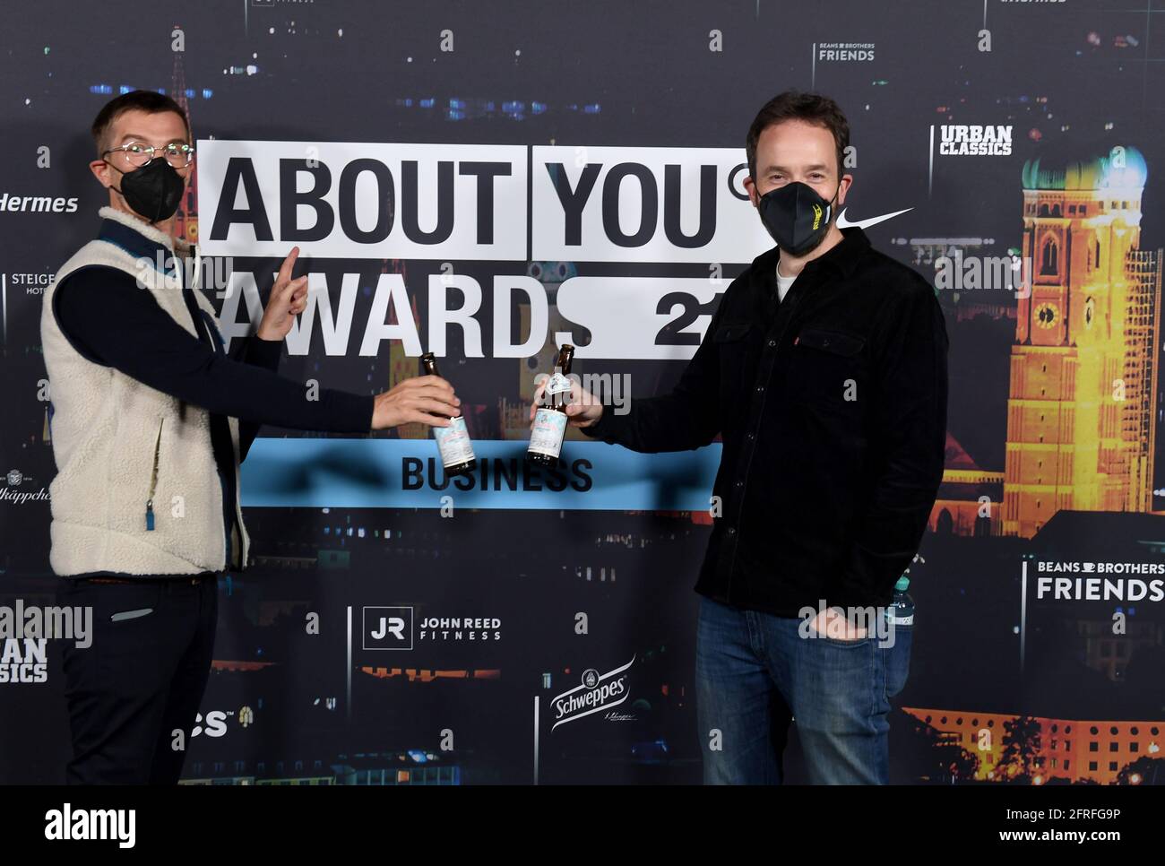 Munich, Germany. 20th May, 2021. Joko Winterscheidt (l) and Philipp Westermeyer toast each other at the 'About You' awards ceremony. The social media personalities of the year are honored in the categories Style, Sports, Business, Empowerment and Digital Art. Credit: Felix Hörhager/dpa/Alamy Live News Stock Photo