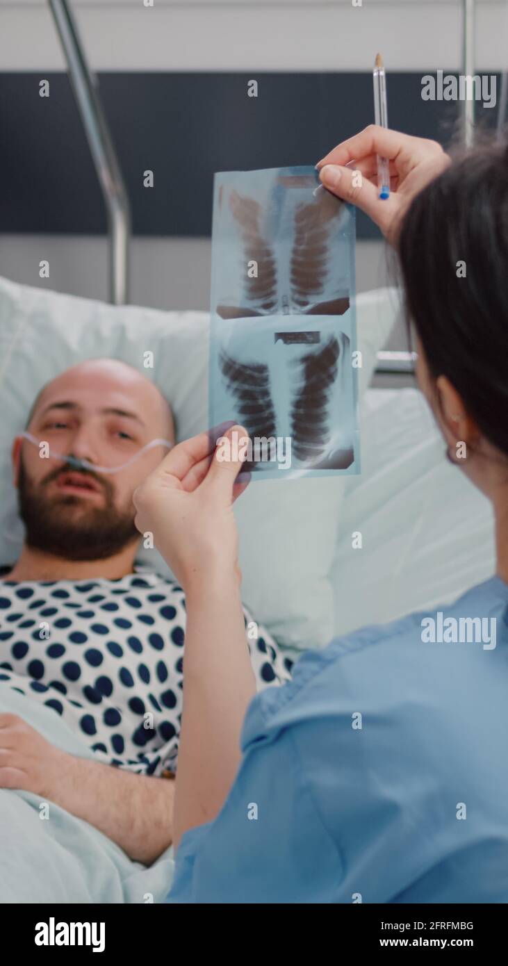 Closeup of woman nurse showing bones radiography monitoring sickness ...