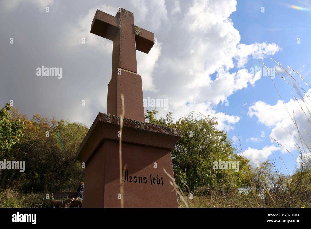 Stone cross in the Palatinate Forest (Germany) with the inscription Jesus lebt (Jesus lives) Stock Photo