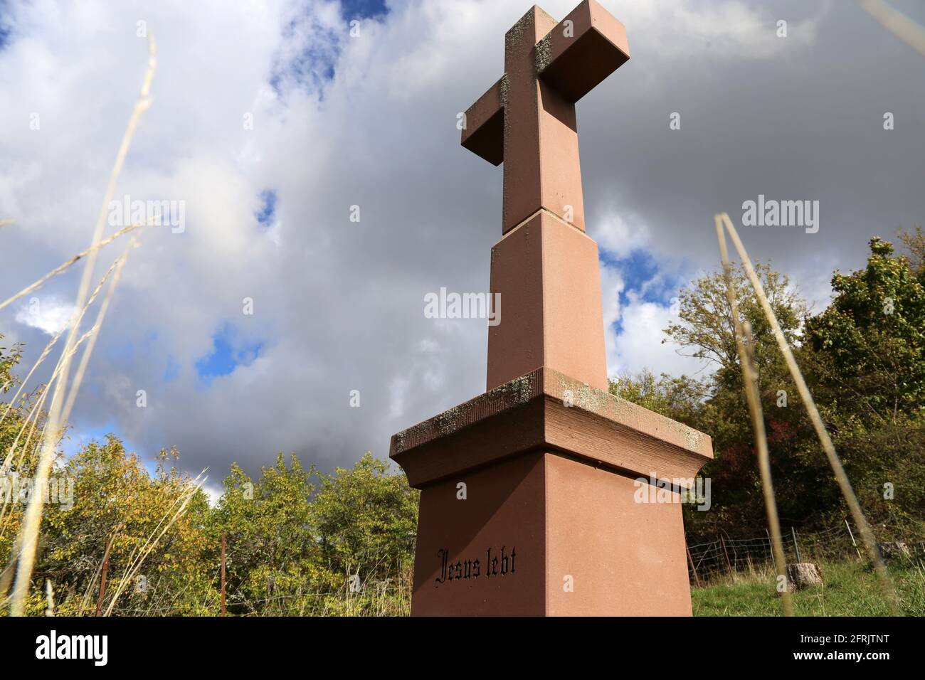 Stone cross in the Palatinate Forest (Germany) with the inscription Jesus lebt (Jesus lives) Stock Photo