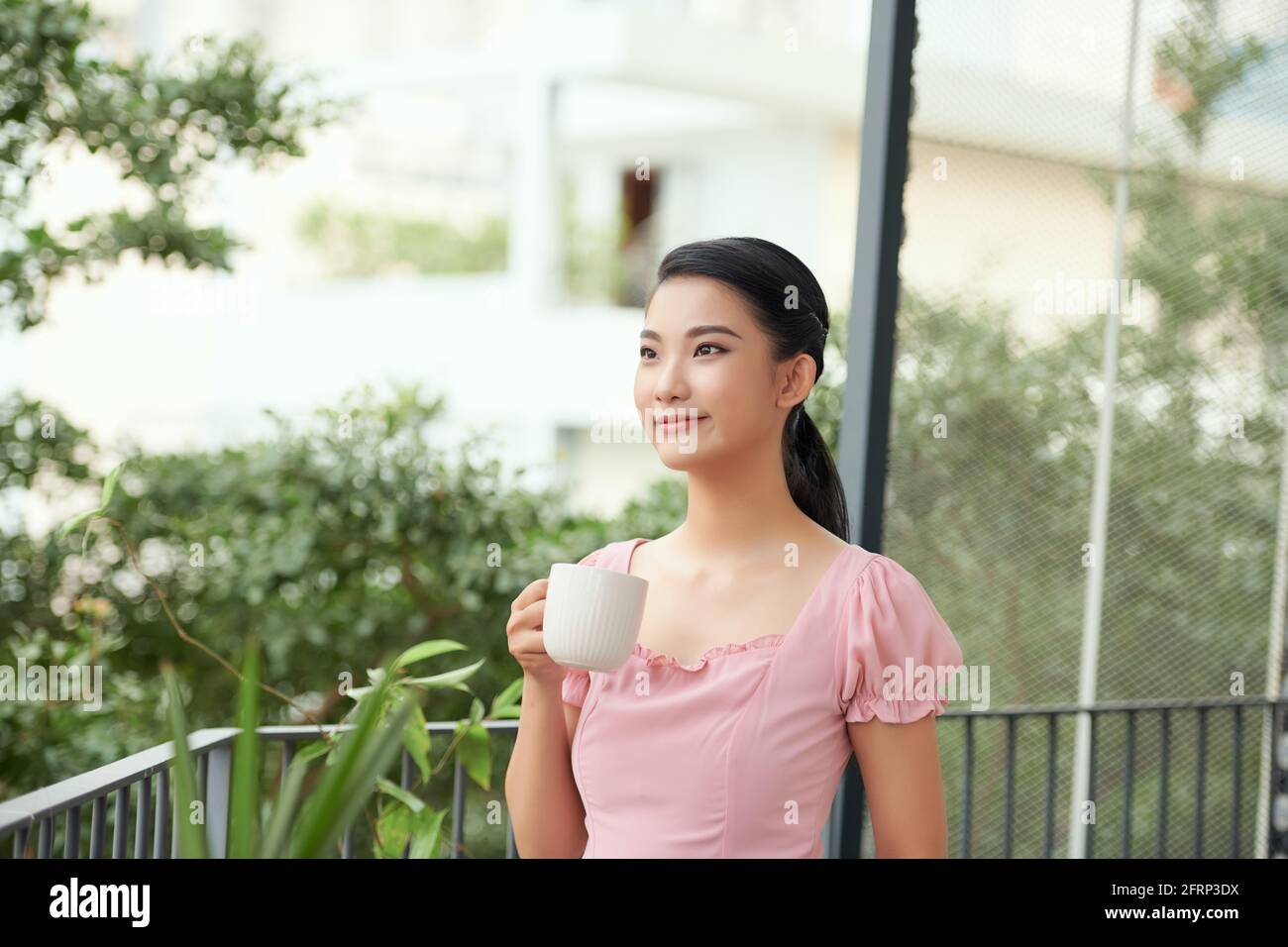 A young asian woman enjoying her morning coffee Stock Photo - Alamy