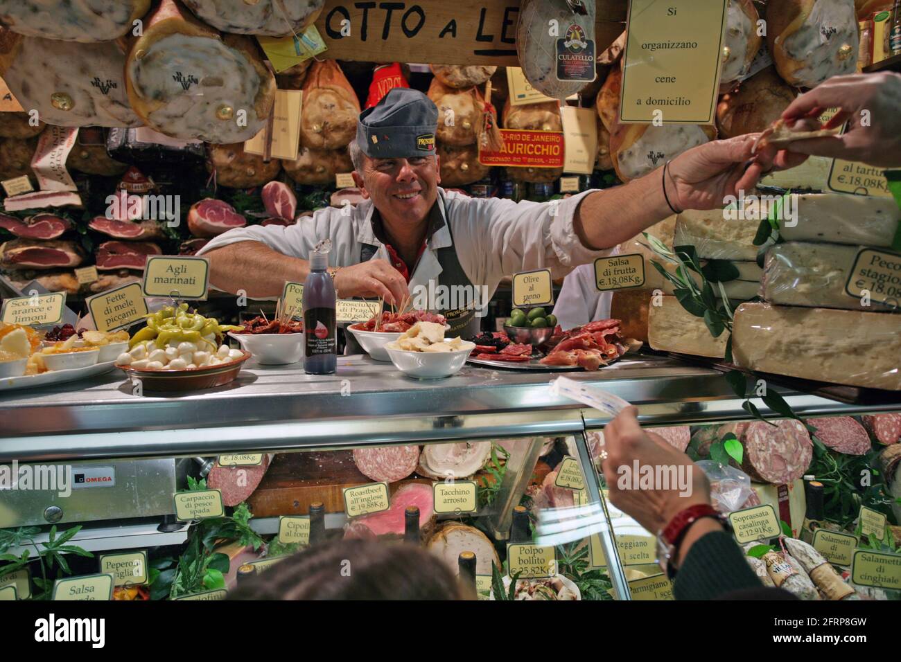 Delicatessen and dry cured meat seller in the central market in Florence, Tuscany , Italy Stock Photo