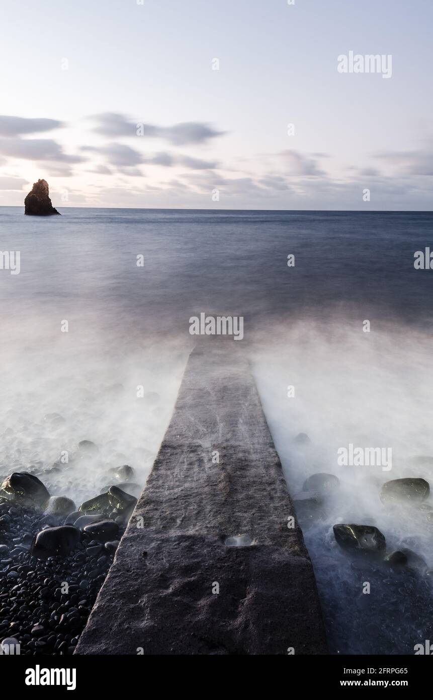 Stone jetty leading into the sea, Madeira. Stock Photo