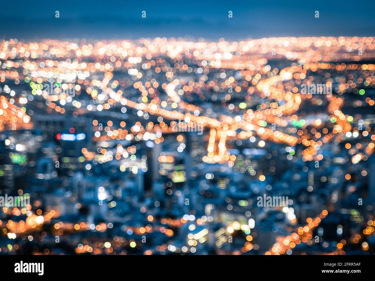 Bokeh of Cape Town skyline from Signal Hill after sunset during the blue hour - South Africa modern city with spectacular nightscape panorama Stock Photo