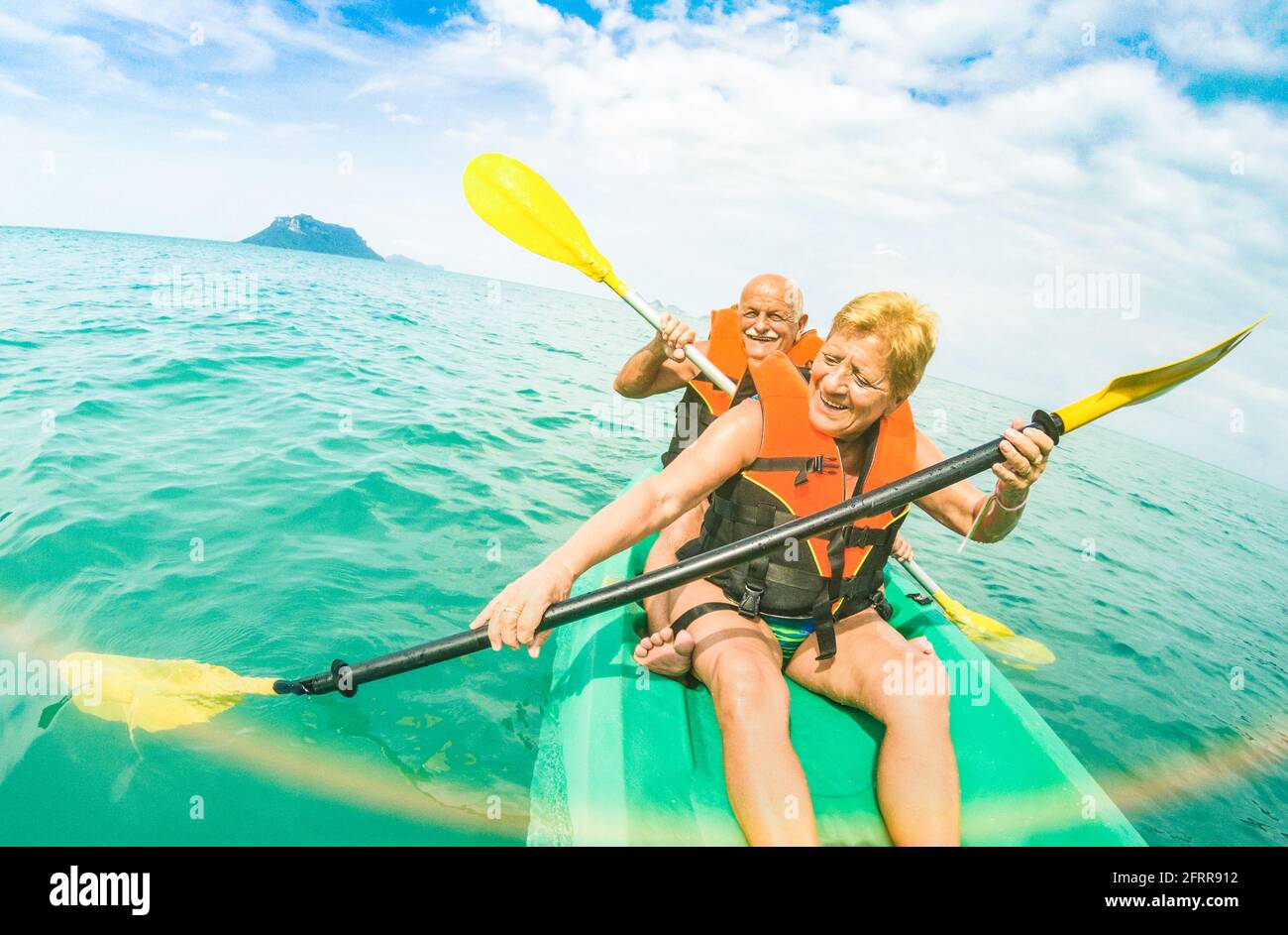 Senior happy couple taking travel selfie on kayak at Ang Thong marine park in Ko Samui - Trip to Thailand wonders - Active elderly concept Stock Photo