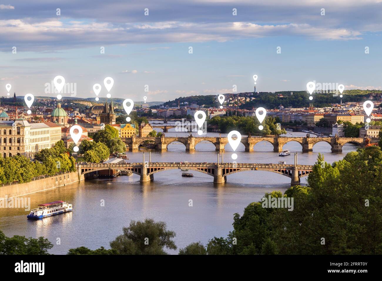 Map pin icons on Prague cityscape. Scenic view of buildings and bridges over Vltava River in Prague, Czech Republic, on a sunny day. Stock Photo